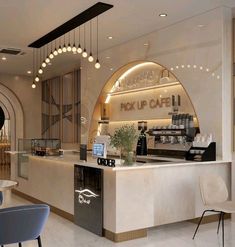 the interior of a coffee shop with an arched ceiling and white marble counter top, along with blue chairs