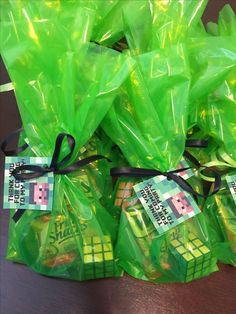 green bags tied together with black ribbon on table