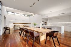 an open floor plan with wood floors and white walls