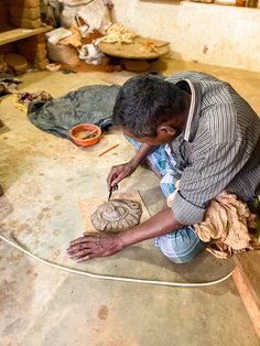 a man working on a piece of pottery