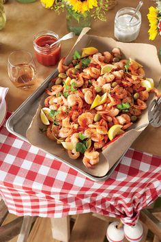 a pan filled with shrimp and vegetables on top of a table