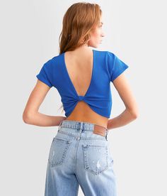 the back of a woman's blue top that is cut out and has holes in it