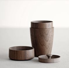 two wooden cups sitting next to each other on a table