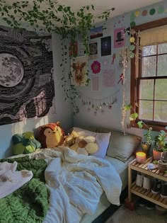 a bed with stuffed animals on it in a bedroom next to a window and potted plants