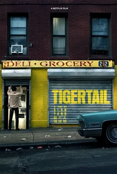 an old car parked in front of a building with a storefront on the side