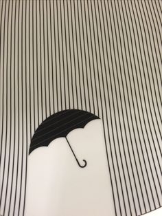 an umbrella with black and white stripes on it is in the middle of a photo