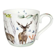 a coffee cup with an image of a deer in the woods on it's side