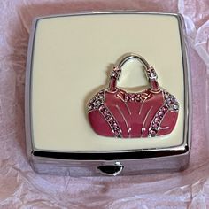 a pink purse is sitting in a white box