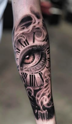 a man's arm with an eye and clock on it