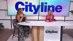 two women sitting at a table in front of a cityline tv screen with the words cityline on it