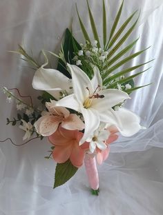 a bridal bouquet with pink and white flowers on it's side, in front of a white background