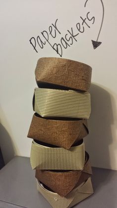 a stack of ties sitting on top of a table next to a paper heart sign