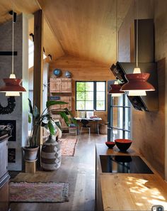 a living room filled with furniture and wooden walls