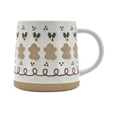 a white and brown coffee mug with holly decorations