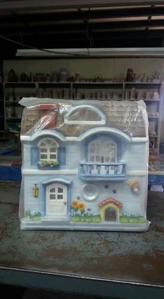 a plastic doll house sitting on top of a table