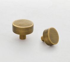 two brass knobs on a white background