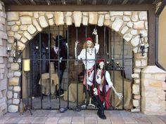 two skeletons are behind bars in a jail cell