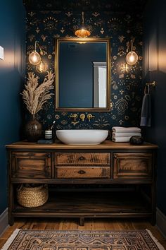 a bathroom with blue walls and a wooden vanity topped with a white sink under a large mirror