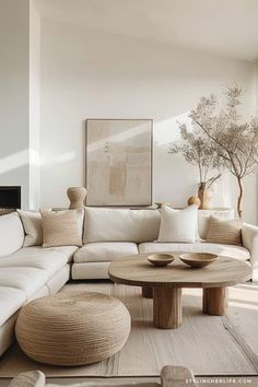 a living room with white couches and pillows