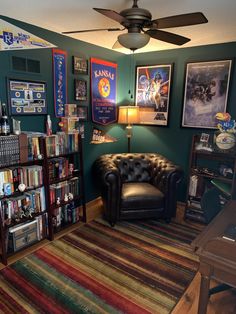 a living room filled with lots of books and furniture next to a book shelf full of movies