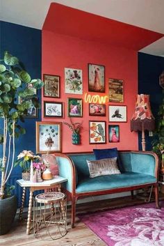 a living room filled with furniture and pictures on the wall next to a stair case