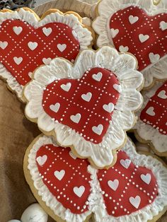 heart shaped cookies with white and red decorations