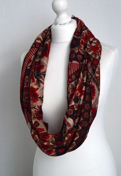 "This stunning boho scarf has a vibrant floral design in red black and cream to make a silk infinity scarf suitable as a gift for any woman. This light weight scarf has been sewn from a pure silk sari to make this sophisticated silk scarf the perfect fashion accessory. This infinity scarf has been sewn from a vintage pure silk sari to make a lovely, simple to wear accessory: just wrap it twice or three times around your neck, or fold in half & slip one end through the other - a versatile acc Cream Sari, Sophisticated Boho, Light Weight Scarf, Boho Scarf, Womens Scarf, Bohemian Fall, Boho Scarfs, Vintage Sari, Loop Scarf