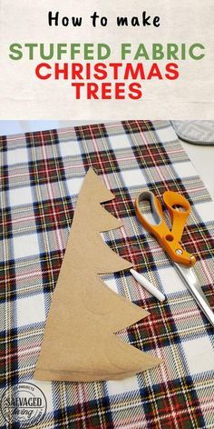 a pair of scissors sitting next to a cut out christmas tree