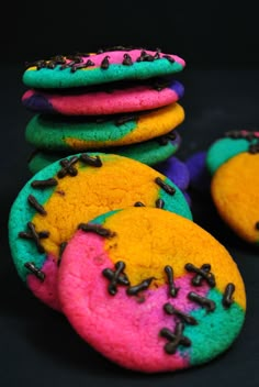 colorful cookies stacked on top of each other with sprinkles