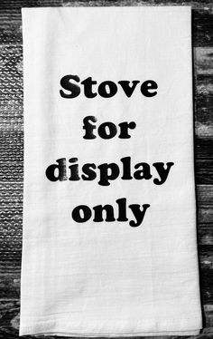 a tea towel that says stove for display only on the side of a wooden table