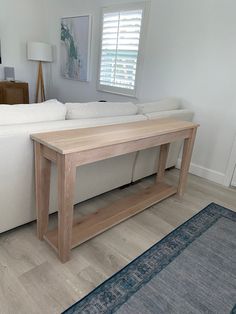 a white couch sitting next to a wooden table