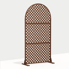 an arched wooden trellis on a white surface