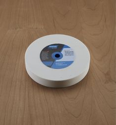 a white disc sitting on top of a wooden table