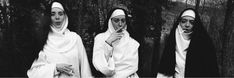 three women dressed in nun costumes standing next to each other with their hands together and looking at the camera