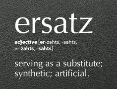 the word ersatz is written in white on a black leather textured surface