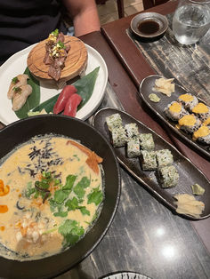 a table topped with plates and bowls filled with different types of food on top of it