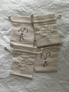 four white towels with embroidered snowflakes on them