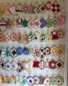 there are many crocheted items hanging on the wall