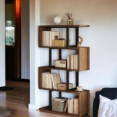 a bookshelf filled with lots of books on top of a hard wood floor