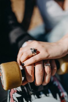 two people holding hands with rings on them