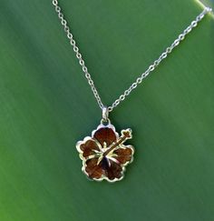 In Hawaii, flowers symbolize all that is positive. This 925 sterling silver pendant features our original Hibiscus flower motif paired with Hawaii's own Koa wood. Wear this Koa wood Hibiscus pendant as a symbol of delicate beauty, unity, and peace. **All orders come with a jewelry box, and polishing cloth. Koa Wood, Jewelry Essentials, Hibiscus Flowers, Daughter Love, Hibiscus, Sterling Silver Pendants, Silver Pendant, Beautiful Necklaces, Jewelry Box