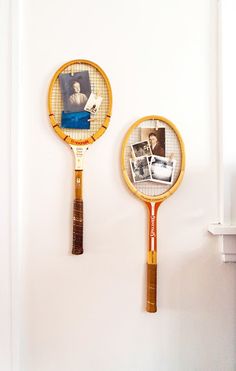 two tennis racquets hanging on the wall next to each other with photos