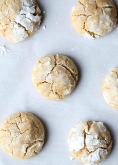 six cookies are on a baking sheet ready to be baked