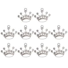 six silver crowns with crystal balls on each side and one tiable in the middle