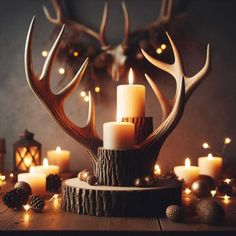 candles are lit in front of deer antlers