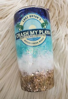 a blue and white cup sitting on top of a fur covered floor with the words crash my playa written on it