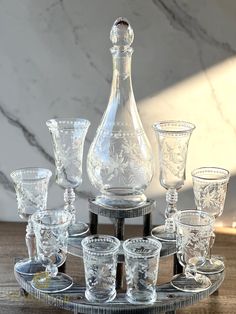 an assortment of glassware is displayed on a tray