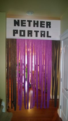 purple streamers are hanging from the wall in front of a sign that says nether portal