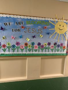 a bulletin board with flowers, butterflies and the words we are blooming for jesus