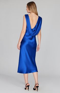 Our signature bias cut silhouette, updated with a gracefully draped front and low back detail. Cut in a flattering midi length with a clean baby hem finish. This dress is unlined and needs no closures thanks to the nature of bias cut fabric. Elegant Blue Cowl Neck Dress, Fitted Bias Cut Midi Dress With Cowl Neck, Chic Blue Cowl Neck Dress, Evening Draped Midi Dress With Ruched Back, Draped Midi Dress With Ruched Back For Evening, Fitted Bias Cut Midi Dress With Cowl Back, Evening Midi Dress With Bias Cut And Cowl Neck, Formal Midi Dress With Bias Cut And Cowl Back, Fitted Midi Dress With Bias Cut And Cowl Back